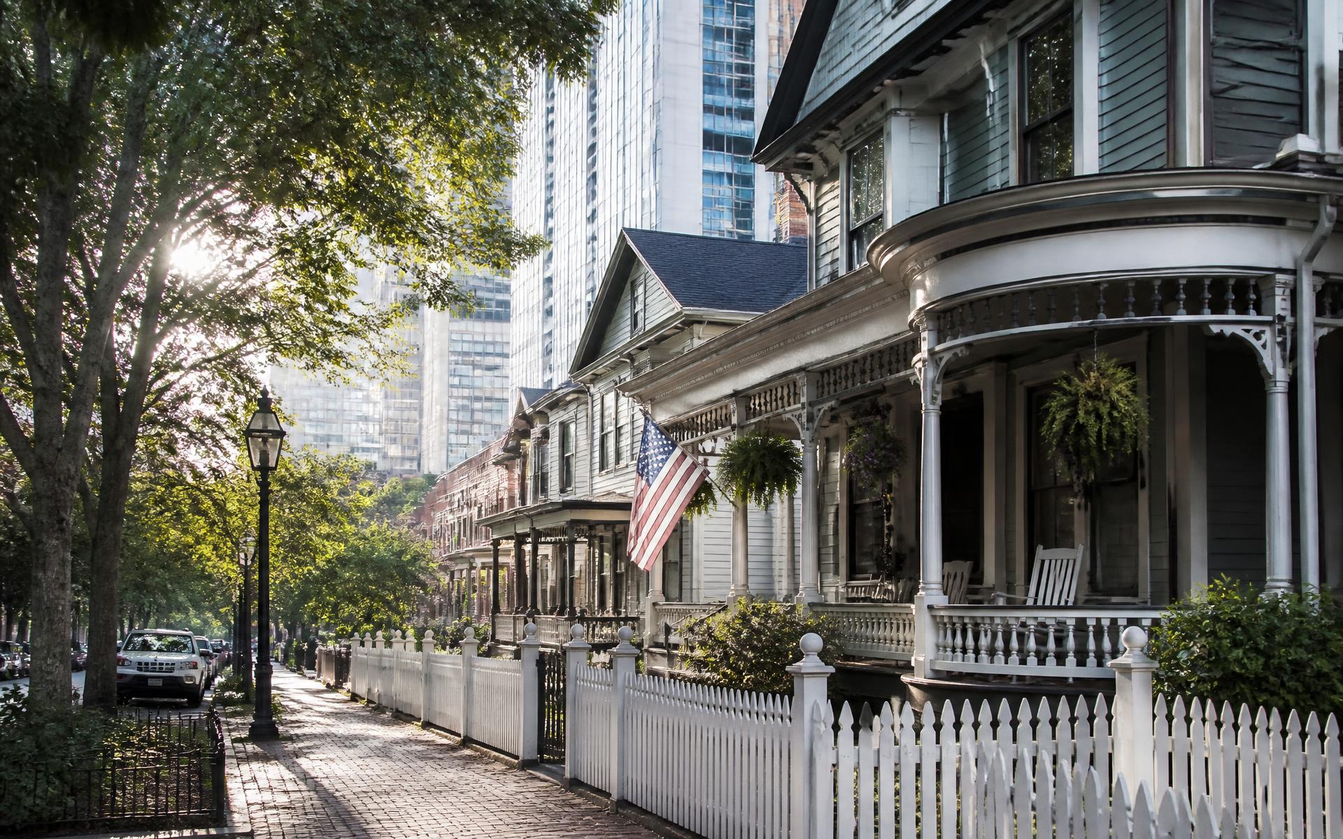Restored Victorian houses in the Fourth Ward historic district beneath Uptown towers