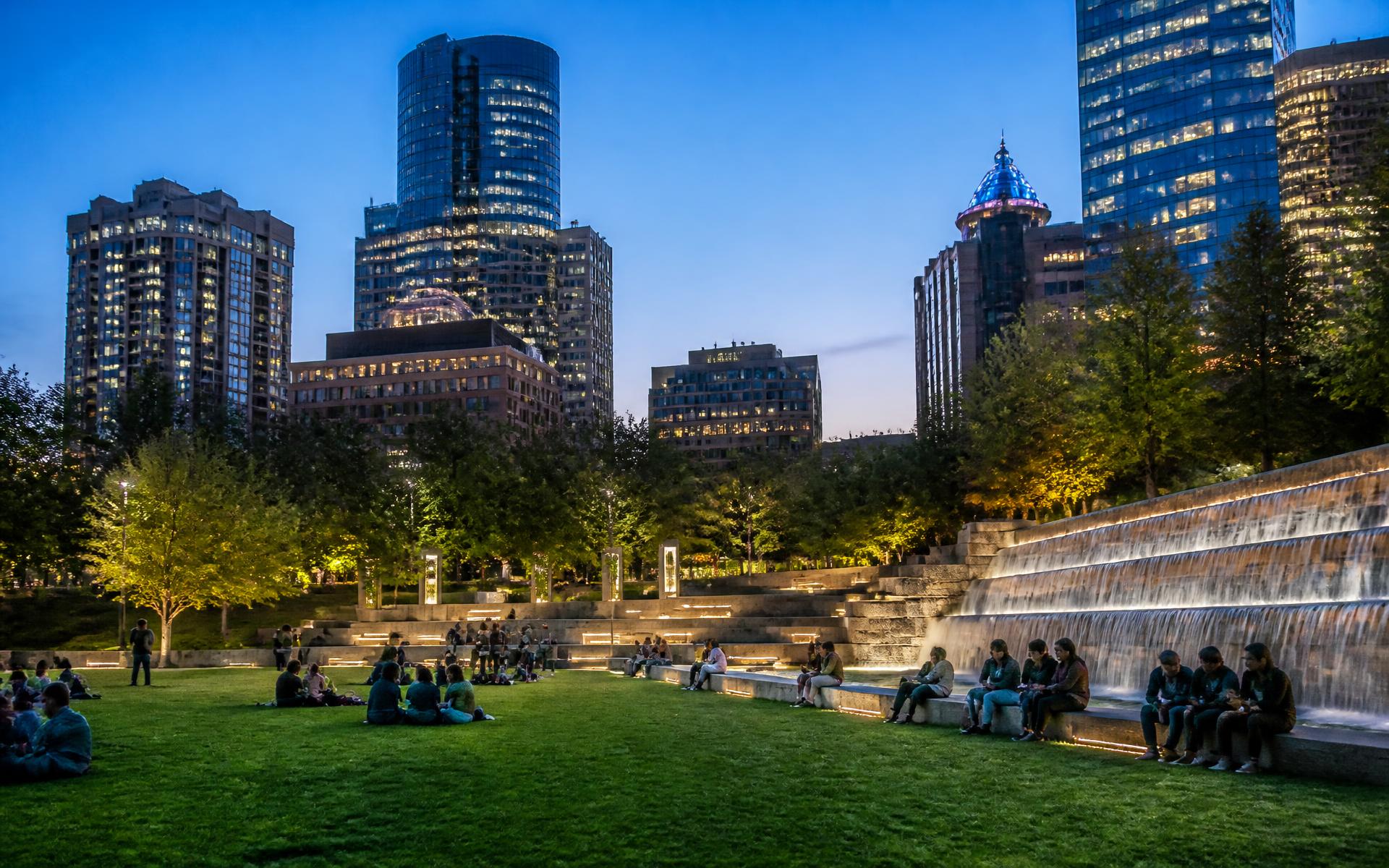 Romare Bearden Park at dusk with the Uptown Charlotte skyline behind